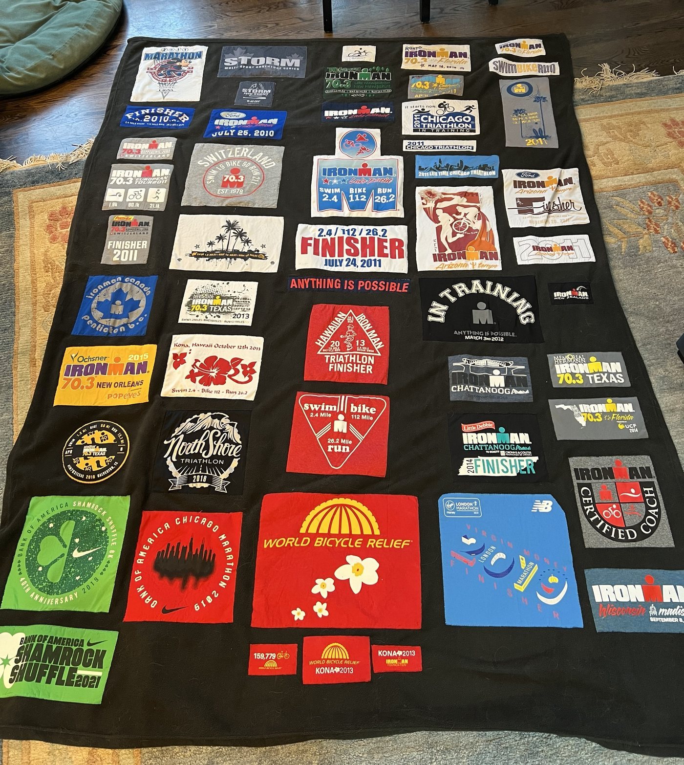 A quilt sewn from race shirts: Ironman finishes, 70.3s, marathons and a World Bicycle Relief jersey